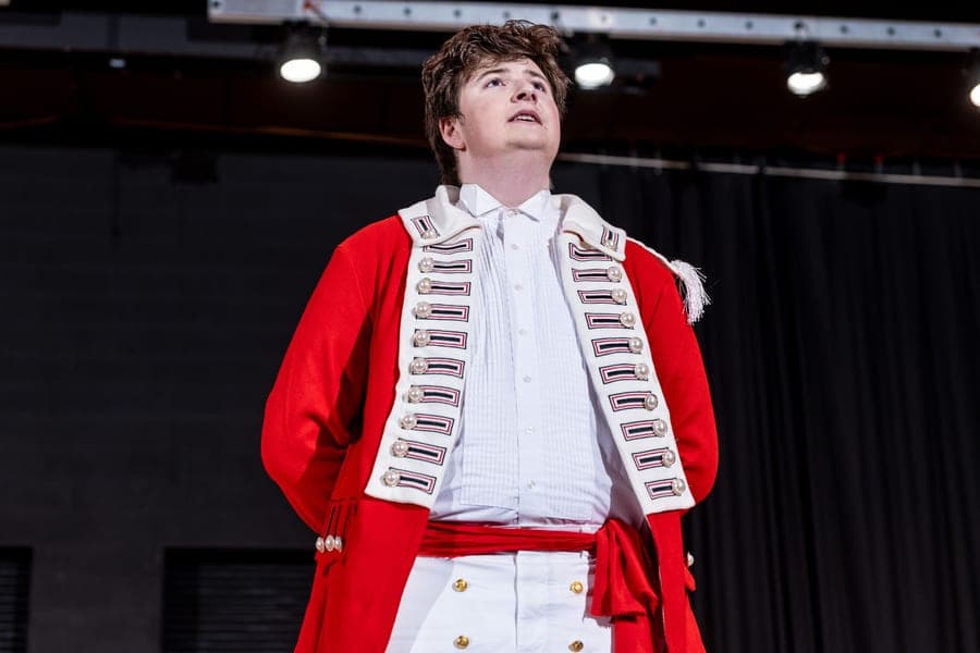 Performer in red military coat